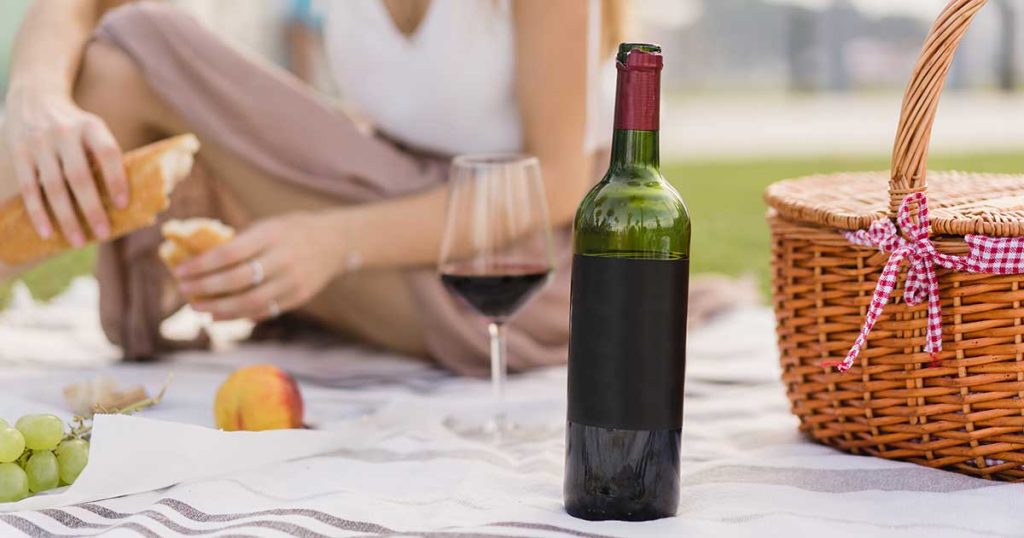 glass bottle of wine at picnic