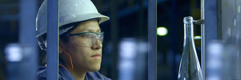 employee makes glass bottles