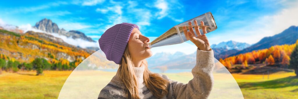 Woman Prioritizing Health and Drinking from Glass Bottle