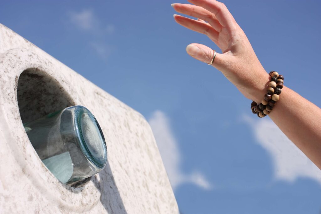 person recycling glass bottle