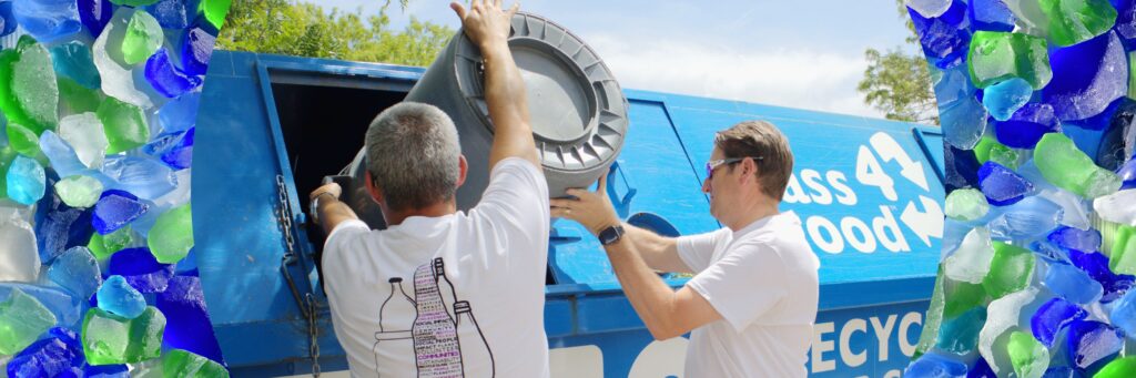 o-i employees recycle glass at a glass4good bin